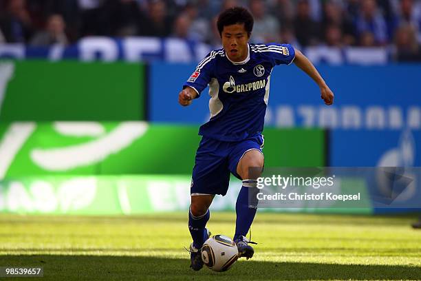 Hao Junmin of Schalke runs with the ball during the Bundesliga match between FC Schalke 04 and Borussia Moenchengladbach at the Veltins Arena on...