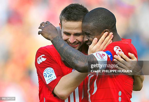 Lille's midfielder Yohan Cabaye is congratuled by his teammate midfielder Rio Mavuba after scoring a goal during the French L1 football match Lille...