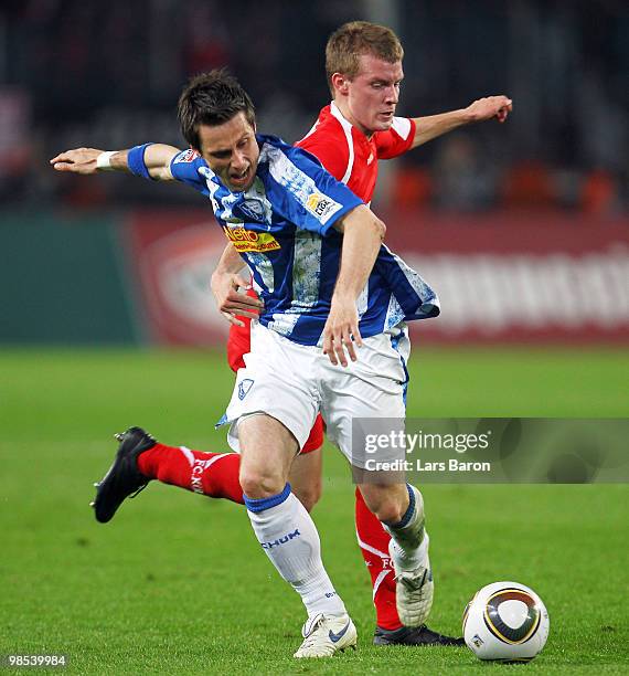 Philipp Boenig of Bochum is challenged by Daniel Brosinski of Koeln during the Bundesliga match between 1. FC Koeln and VfL Bochum at...