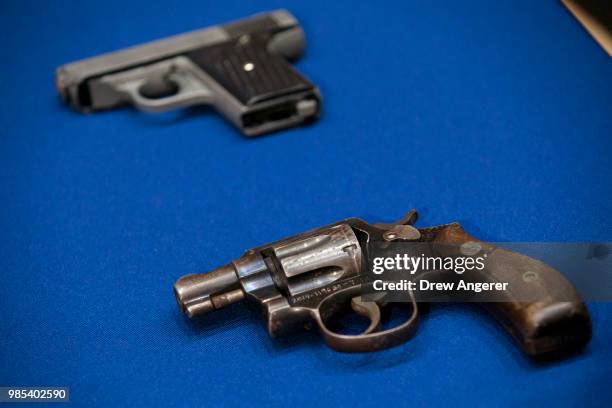 Guns belonging to members of the Mac Balla gang are displayed during a press conference about gang violence at New York City Police Department...