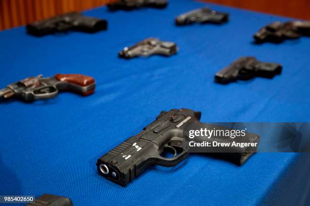Guns belonging to members of the Mac Balla gang are displayed during a press conference about gang violence at New York City Police Department...
