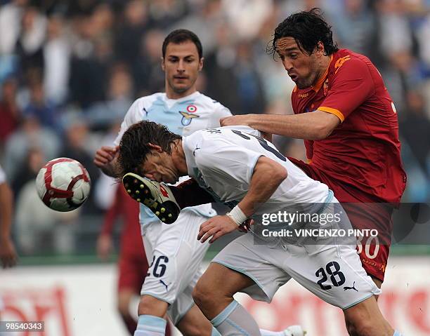 Roma's forward Luca Toni clashes with Lazio's defender Guglielmo Stendardi during their Serie A football match at Olympic stadium in Rome on April...