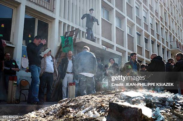 French railway company SNCF employees demonstrate next to a fire on April 19, 2010 at the train station Gare Perrache in Lyon, eastern France, as...