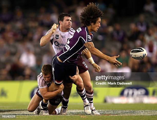 Kevin Proctor of the Storm offloads as he is tackled during the round six NRL match between the Melbourne Storm and the Manly Sea Eagles at Etihad...