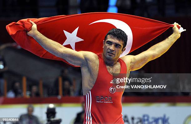 Turkish Nazmi Avlica celebrates after he won the gold medal against Russian Aleksey Mishin during the men's Free Style Wrestling 84 kg event at the...