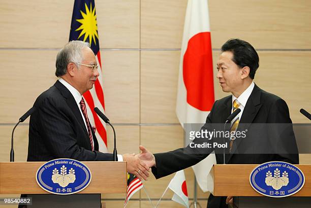 Japanese Prime Minister Yukio Hatoyama shakes hands with Prime Minister of Malaysia Najib Tun Razak at the premier's official residence on April 19,...