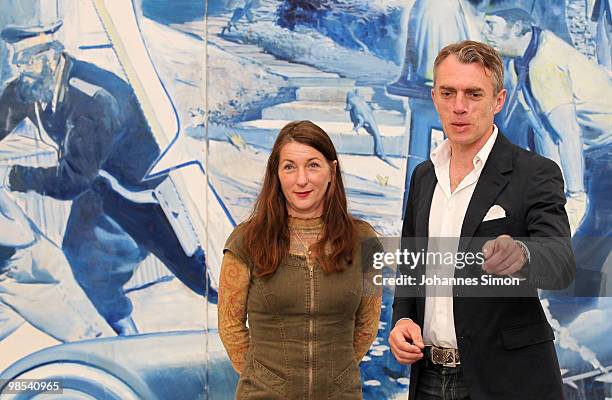 German artist Neo Rauch and his wife Rosa Loy pose in front of Rauch's painting 'Das Blaue' at Pinakothek der Moderne art museum on April 19, 2010 in...