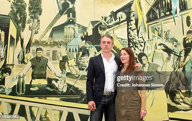 German artist Neo Rauch and his wife Rosa Loy pose in front of Rauch's painting 'Kalimuna' at Pinakothek der Moderne art museum on April 19, 2010 in...