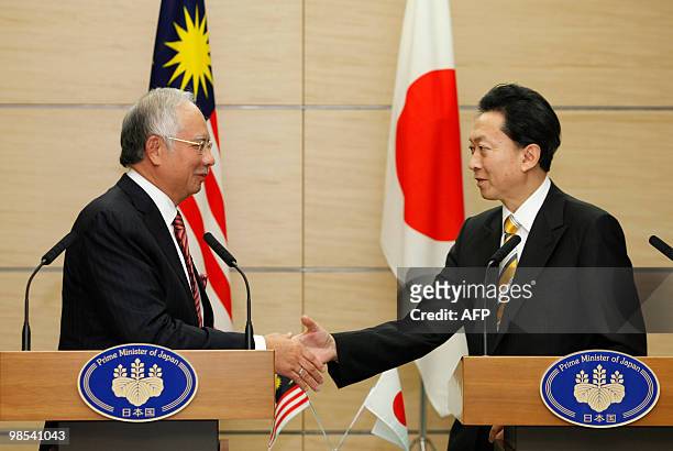 Malaysia's Prime Minister Najib Razak shakes hands with Japanese Prime Minister Yukio Hatoyama at the latter's official residence in Tokyo on April...