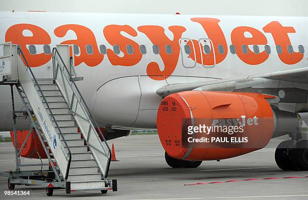 An aircraft belonging to low-cost airline EasyJet is pictured with its engines covered at Liverpool's John Lennon Airport in north-west England, on...