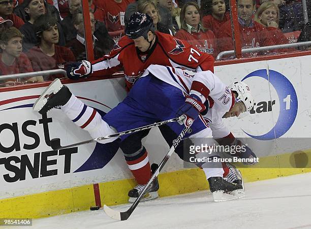 Dominic Moore of the Montreal Canadiens hits Joe Corvo of the Washington Capitals in Game Two of the Eastern Conference Quarterfinals during the 2010...