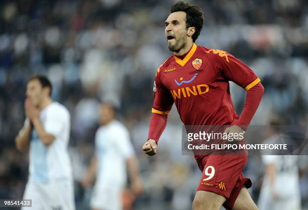Roma's montenegro forward Mirko Vucinic celebrates after scoring a penalty against Lazio during their Serie A football match at Olympic stadium in...