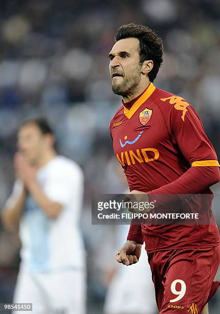 Roma's montenegro forward Mirko Vucinic celebrates after scoring a penalty against Lazio during their Serie A football match at Olympic stadium in...