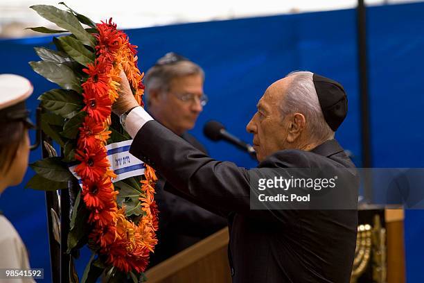 Israeli President Shimon Peres lays a wreath during a ceremony for fallen soldiers during the annual Memorial Day at the Mt. Herzl military cemetery...