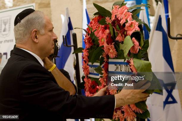 Israel's Prime Minister Benjamin Netanyahu lays a wreath during a ceremony for fallen soldiers during the annual Memorial Day at the Mt. Herzl...