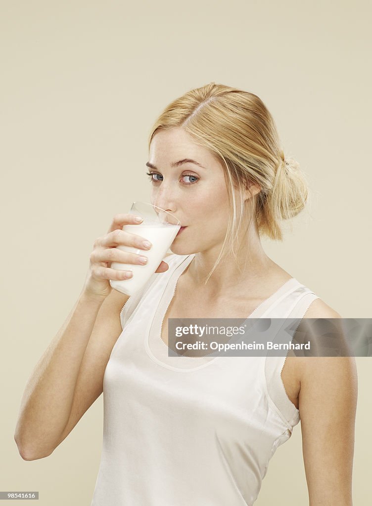 Young woman drinking fresh milk
