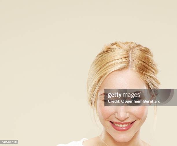 close up of woman smiling and winking  - winking stock pictures, royalty-free photos & images