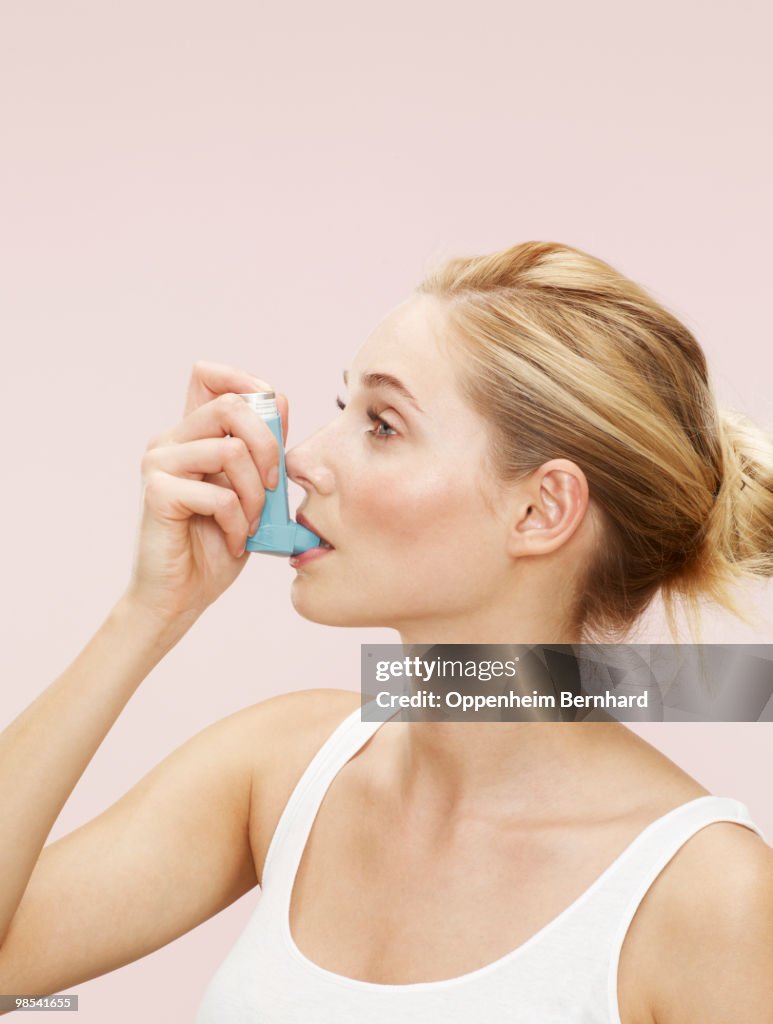 Someone Using Blue Inhaler Woman Using Blue Inhaler High-Res Stock Photo - Getty Images