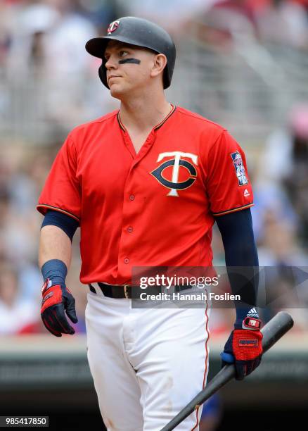 Logan Morrison of the Minnesota Twins reacts to striking out against the Texas Rangers during the game on June 24, 2018 at Target Field in...