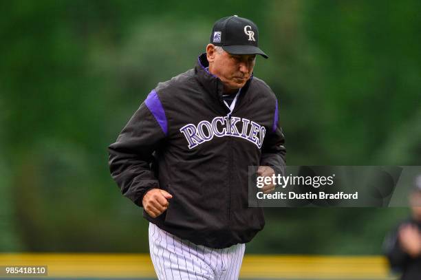 Bud Black of the Colorado Rockies jogs off the field after a mound visit in the first inning of a game against the Miami Marlins at Coors Field on...