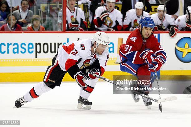 Mike Fisher of the Ottawa Senators battles for the puck with Scott Gomez of the Montreal Canadiens during the NHL game on March 22, 2010 at the Bell...