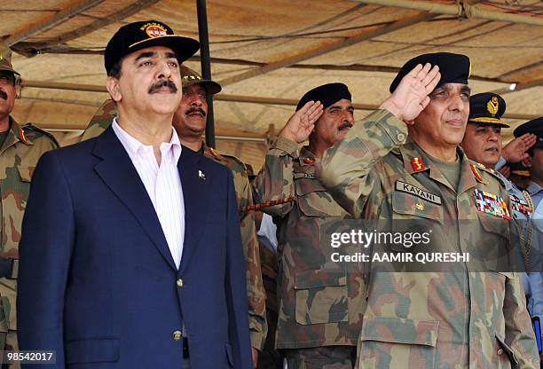 Pakistani Prime Minister Yousuf Raza Gilani and Pakistani Army Chief General Ashfaq Kayani listen national anthem as they arrive to witness a...