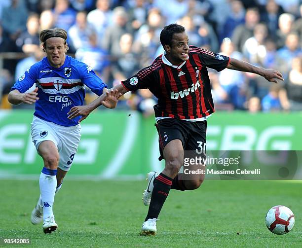 Reto Ziegler of UC Sampdoria battles for the ball against Amantino Mancini of AC Milan during the Serie A match between UC Sampdoria and AC Milan at...
