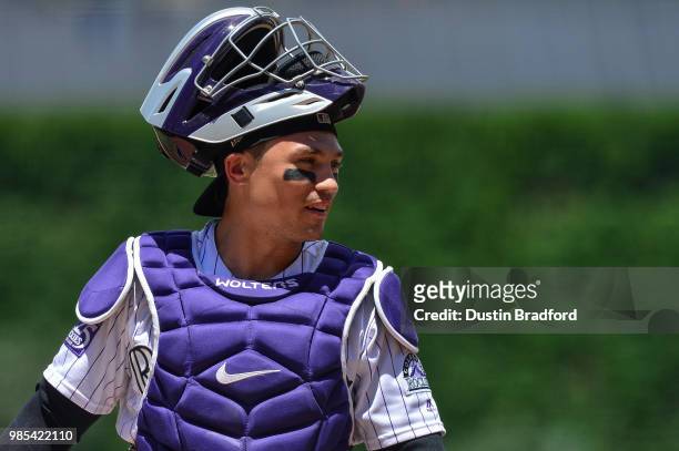 Tony Wolters of the Colorado Rockies looks on during the first inning of a game against the Miami Marlins at Coors Field on June 23, 2018 in Denver,...