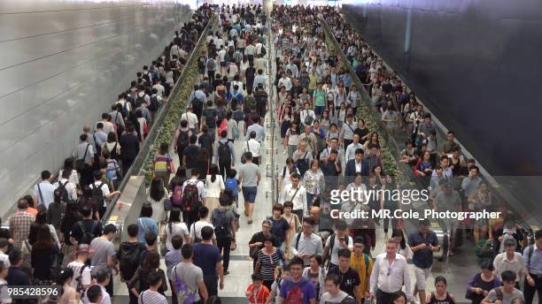 crowd of pedestrian commuters on train station,rush hour in hong kong - airport traffic stockfoto's en -beelden