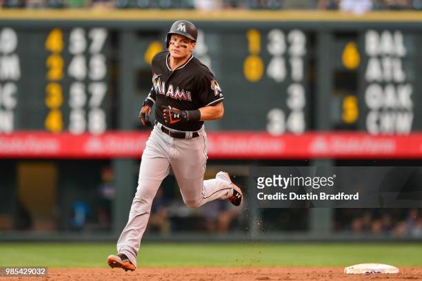 Derek Dietrich of the Miami Marlins rounds the bases after hitting a third inning solo homerun against the Colorado Rockies at Coors Field on June...