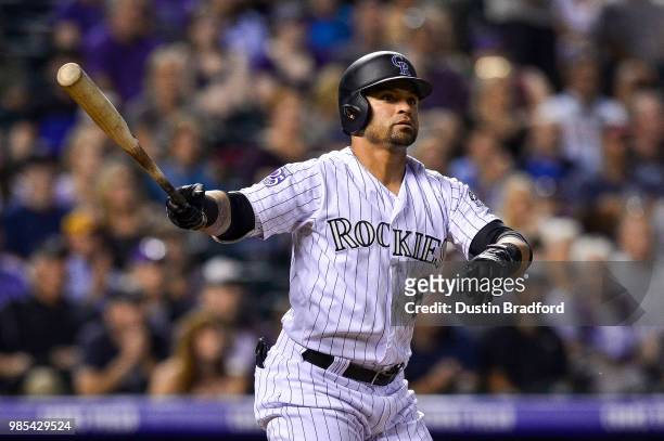 Gerardo Parra of the Colorado Rockies watches the flight of a three-run double in the seventh inning of a game against the Miami Marlins at Coors...
