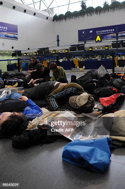 European passengers sleep on the floor of Beijing Capital International airport after flights from China to Europe were cancelled on April 19, 2010....