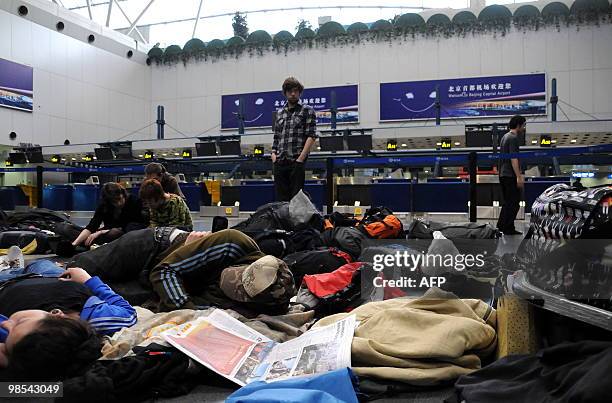 European passengers sleep on the floor of Beijing Capital International airport after flights from China to Europe were cancelled on April 19, 2010....