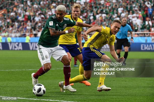 Mexico's forward Jesus Corona and Sweden's defender Ludwig Augustinsson vie for the ball during the Russia 2018 World Cup Group F football match...