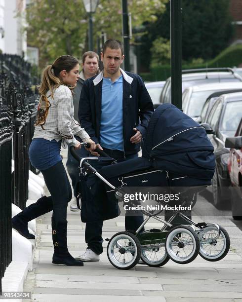 Joe Cole and Carly Cole take a stroll with their baby daughter Ruby Tatiana on April 19, 2010 in London, England.