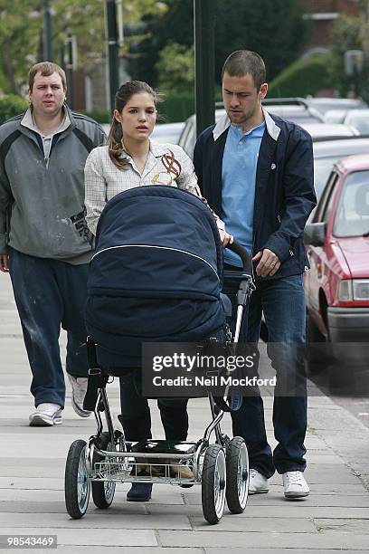 Joe Cole and Carly Cole take a stroll with their baby daughter Ruby Tatiana on April 19, 2010 in London, England.