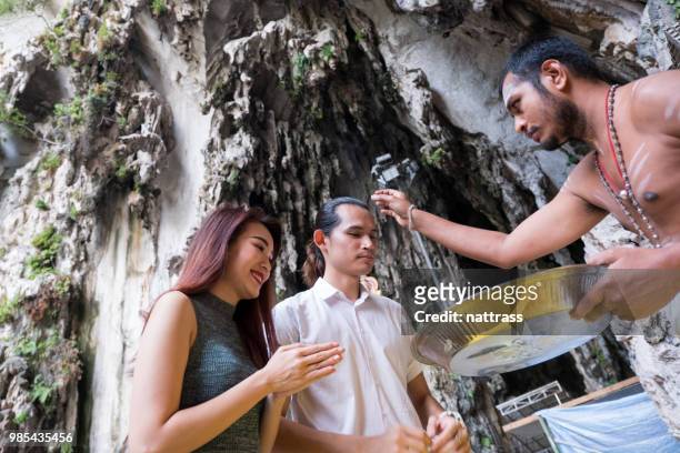 tourists exploring the batu caves - batu caves stock pictures, royalty-free photos & images