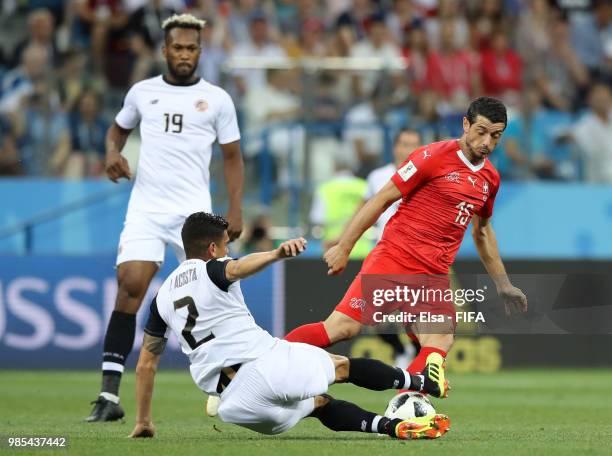 Johnny Acosta of Costa Rica tackles Blerim Dzemaili of Switzerland during the 2018 FIFA World Cup Russia group E match between Switzerland and Costa...