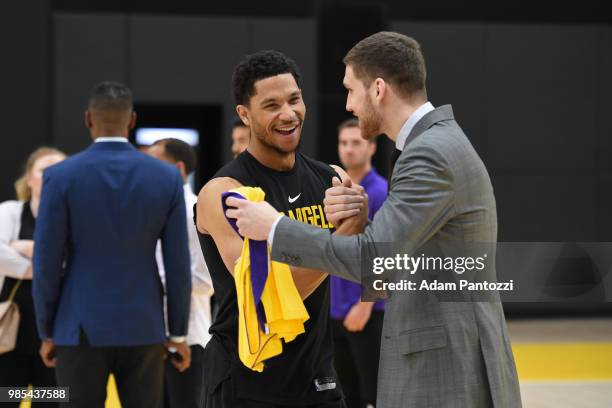 Josh Hart shakes hands with Sviatoslav Mykhailiuk of the Los Angeles Lakers during an introductory press conference at the UCLA Health Training...