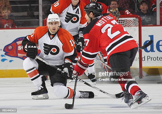 Blair Betts of the Philadelphia Flyers goes down to block a pass by Mike Mottau of the New Jersey Devils in Game Two of the Eastern Conference...