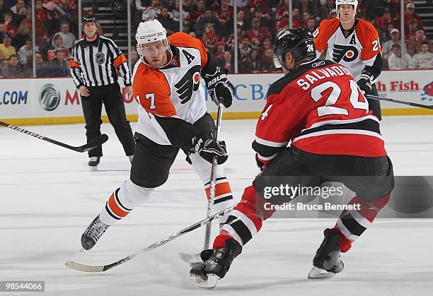 Jeff Carter of the Philadelphia Flyers shoots past Bryce Salvador of the New Jersey Devils in Game Two of the Eastern Conference Quarterfinals during...