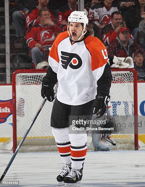 Daniel Carcillo of the Philadelphia Flyers reacts after getting hit in the face by a stick against the New Jersey Devils in Game Two of the Eastern...