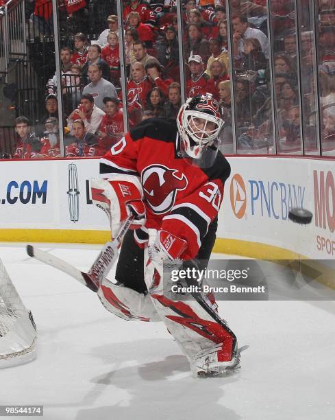 Martin Brodeur of the New Jersey Devils shoots the puck against the Philadelphia Flyers in Game Two of the Eastern Conference Quarterfinals during...