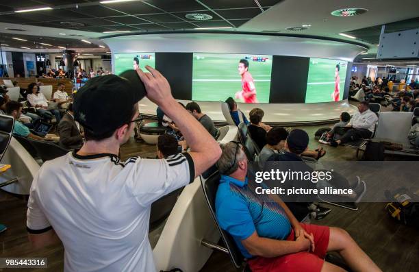 June 2018, Frankfurt am Main, Germany: Passengers watch the World Cup encounter between Germany and South Korea live on big screens at the "adventure...