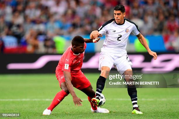 Switzerland's forward Breel Embolo vies for the ball with Costa Rica's defender Johnny Acosta during the Russia 2018 World Cup Group E football match...