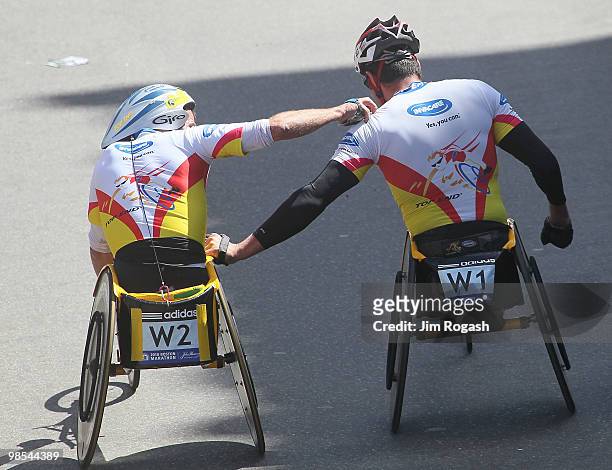 Krige Schabot shares a moment with Ernst Van Dyk who won the mens wheelchair division of the 114th Boston Marathon on April 19, 2010 in Boston,...