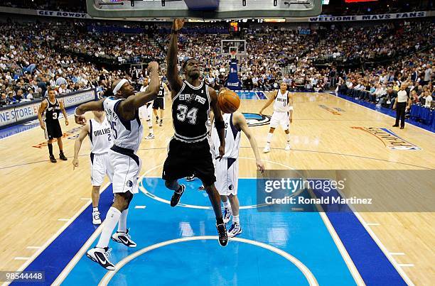 Forward Antonio McDyess of the San Antonio Spurs slams the ball in front of Erick Dampier of the Dallas Mavericks in Game One of the Western...