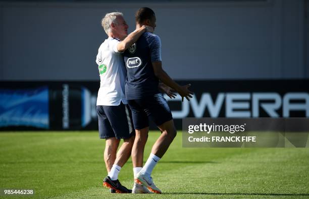 France's head coach Didier Deschamps talks to France's forward Kylian Mbappe during a training session in Istra, west of Moscow on June 27 during the...