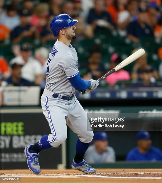 Randal Grichuk of the Toronto Blue Jays doubles in the first inning against the Houston Astros at Minute Maid Park on June 27, 2018 in Houston, Texas.