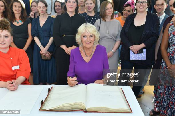 Camilla, Duchess of Cornwall signs the Roll book with T S Elliots pen at The Royal Society of Literature '40 Under 40' fellow induction at The...